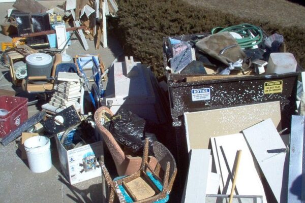 Pile of junk, furniture, and construction debris being collected by waste removal services Kent WA.