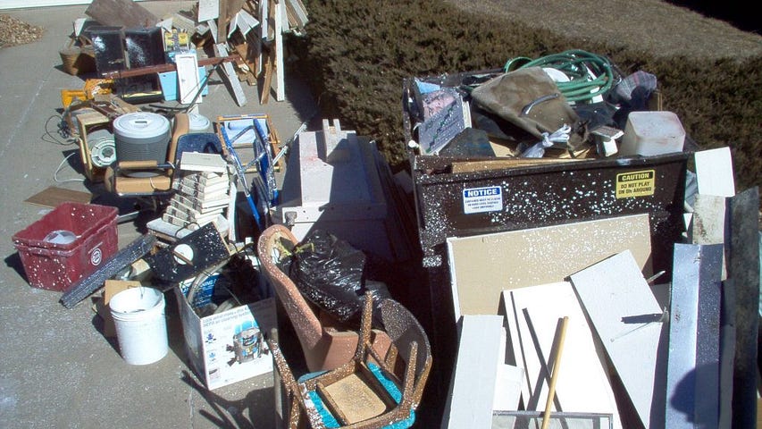 Pile of junk, furniture, and construction debris being collected by waste removal services Kent WA.